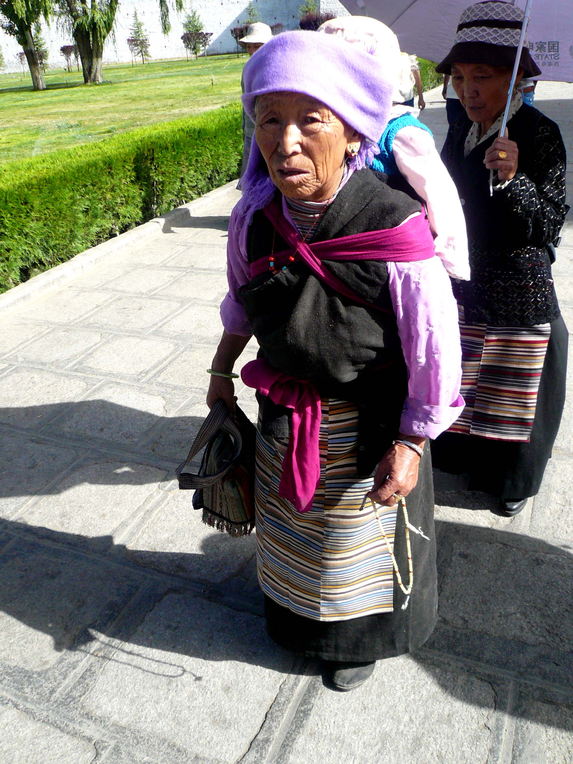 A local old lady doing her daily prayer rounds at the Palace parameters